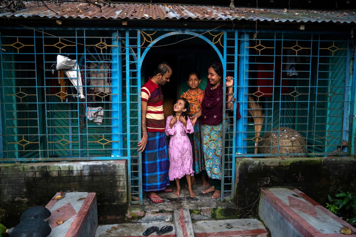 A returned migrant with his family in Bangladesh