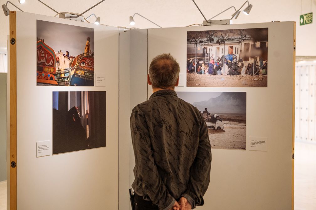 A person views photos in an art exhibition