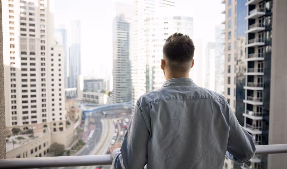 The back of a man looking out at a city
