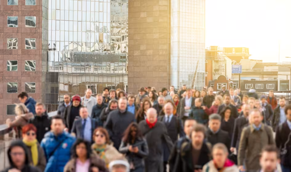 A crowd of people walking across London Bridge