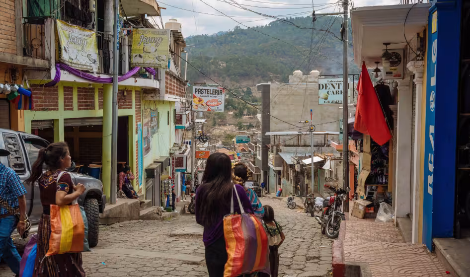 Women walk down a street in Quich&eacute;, Guatemala