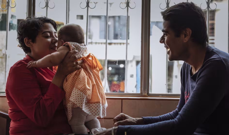 A family with a young child at an Orientation and Assistance Point in Bogota that offers services to Venezuelan refugees and migrants