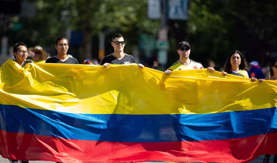 People carry a giant Colombian flag at a parade in Washington, DC