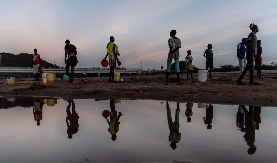 Photo of a group of women collecting water from a riverbed in Kenya