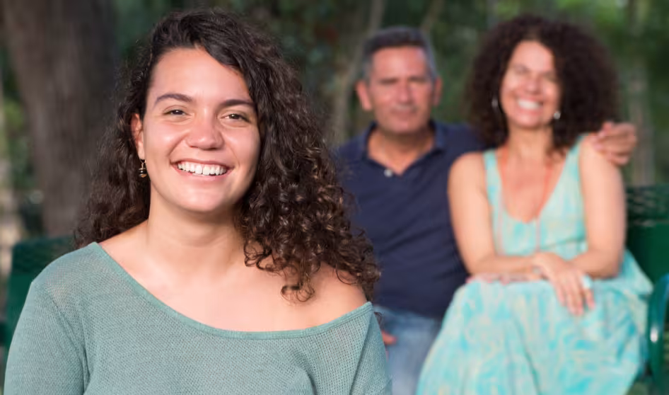 Image of parents posing with daughter