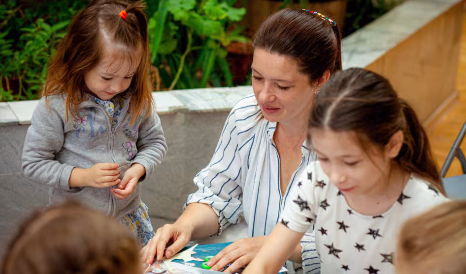 Photo of a teacher from Ukraine organizing activities for refugee children in Moldova