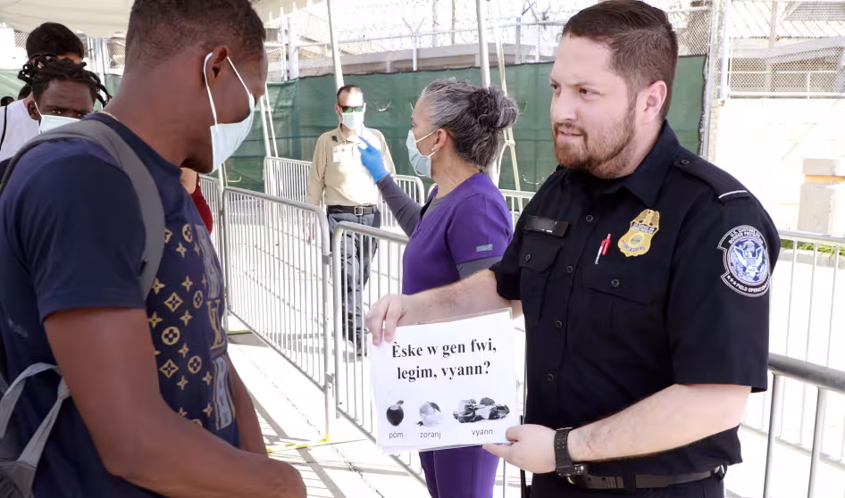 CBP personnel process and screen migrants for possible entry into the U.S.