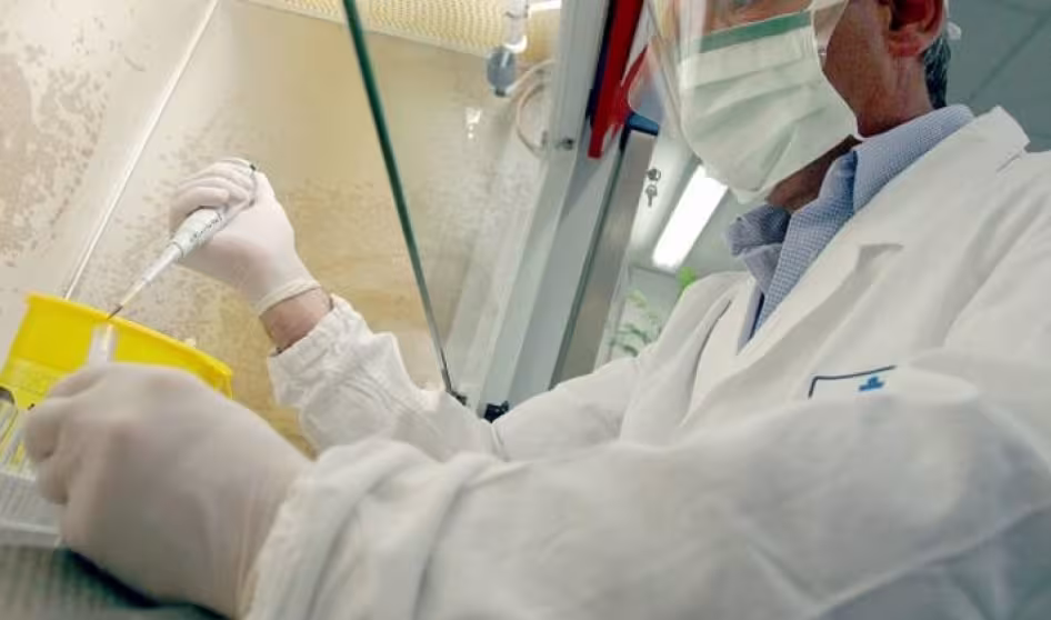 A doctor wearing a face mask performing a test