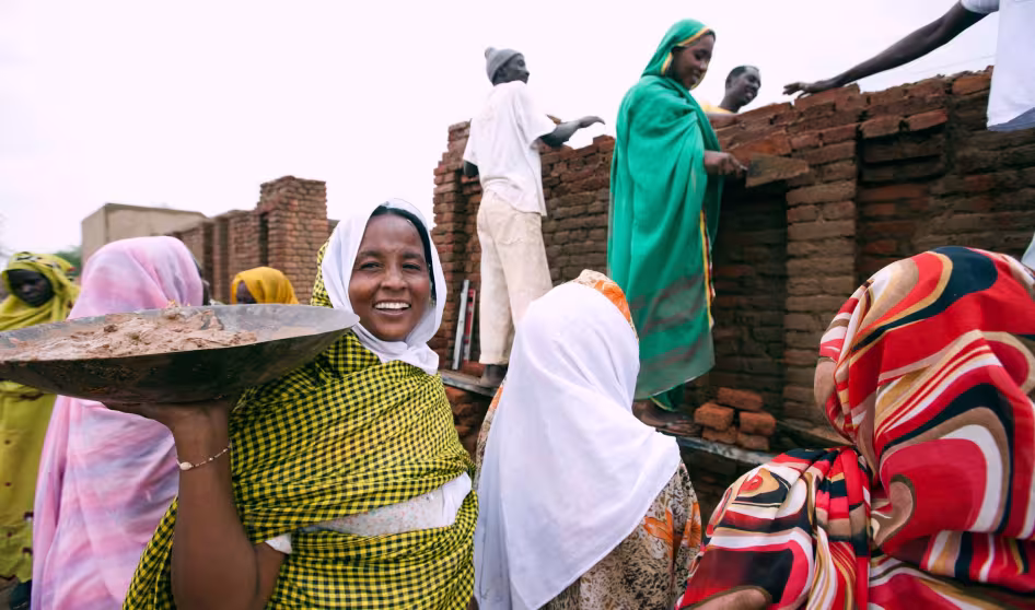 Young women in Darfur learning to construct buildings.