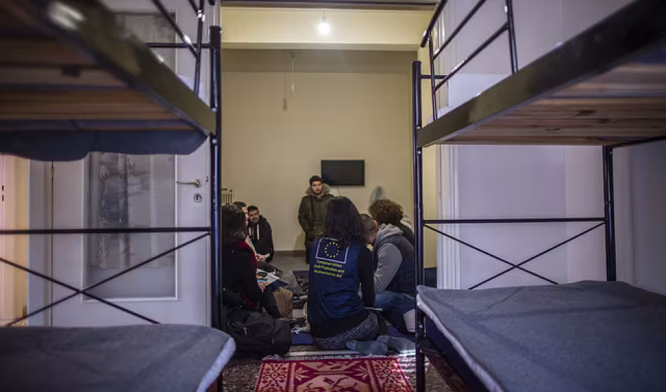 EU official with asylum-seeker family in Greece