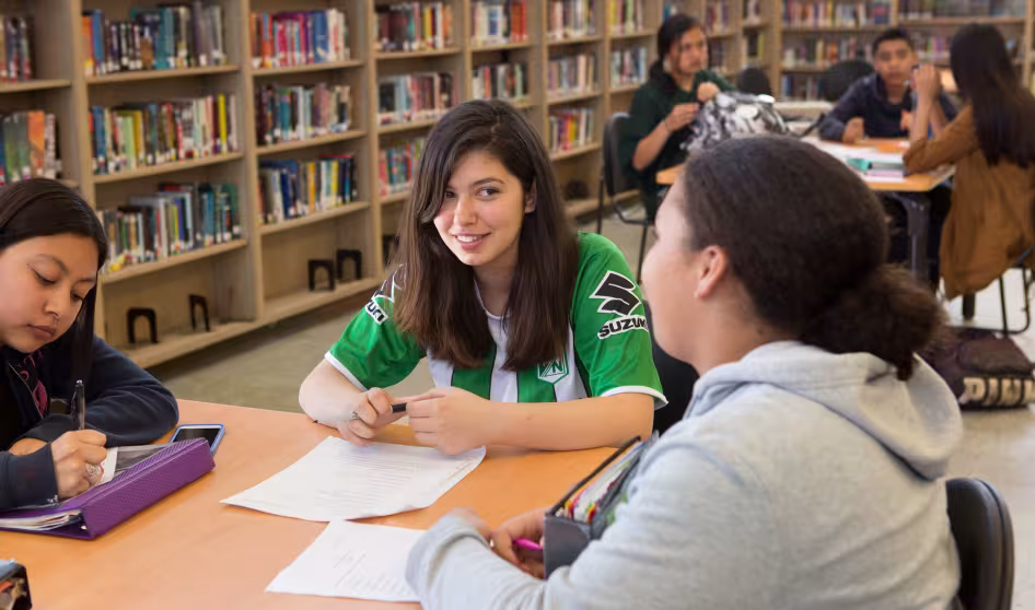 High school students working together in the library