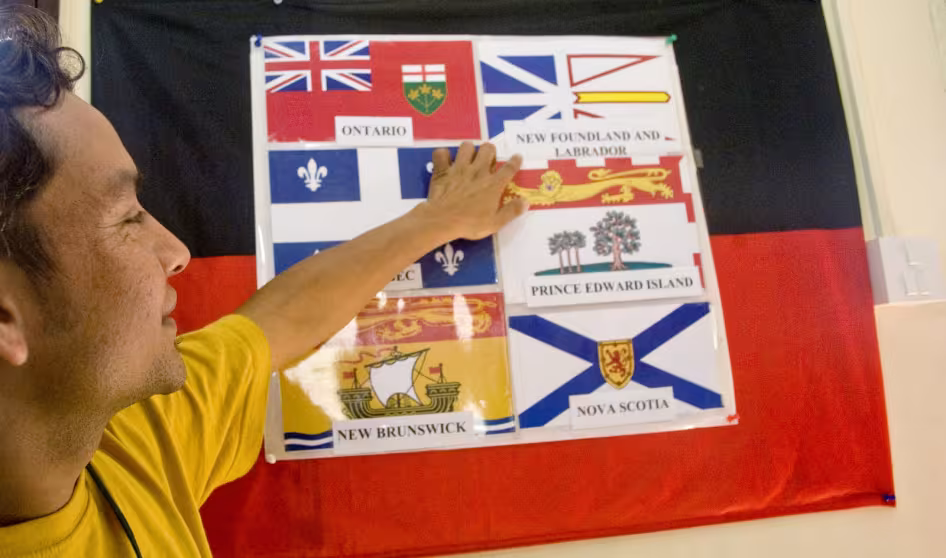 Refugee at an orientation before resettlement to Canada