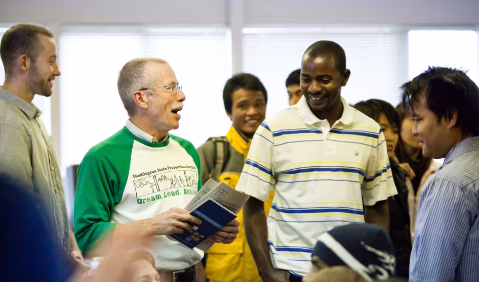 A volunteer and refugees chat at a workshop in Spokane, Washington.