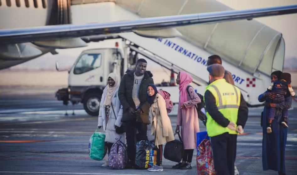 A family of refugees arriving at an airport during resettlement