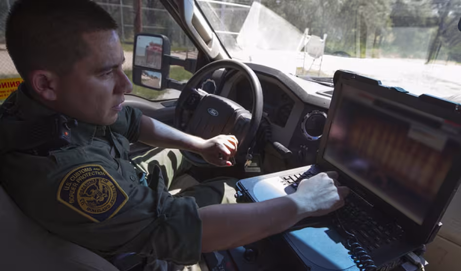 South Texas Border Patrol agent inspects a truck at a CBP checkpoint.