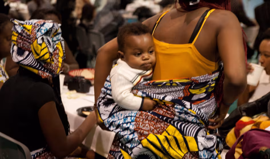Mother and child at a local refugee art auction & fashion show.