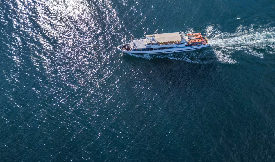 An aerial photo of a small boat at sea