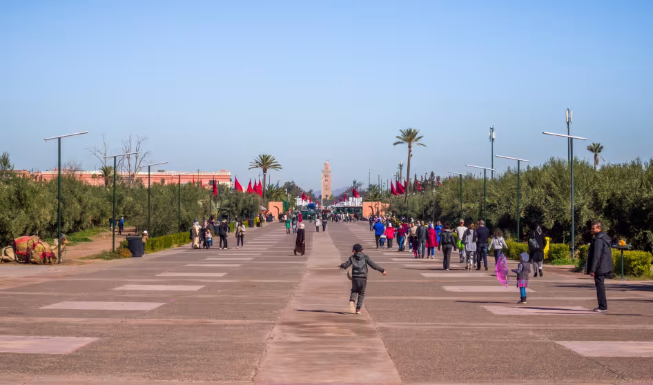 People walk along the road to the Menara Gardens in Marrakech, Morocco