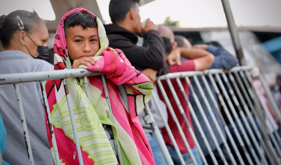 Venezuelans wait in line at the Brazil-Venezuela border