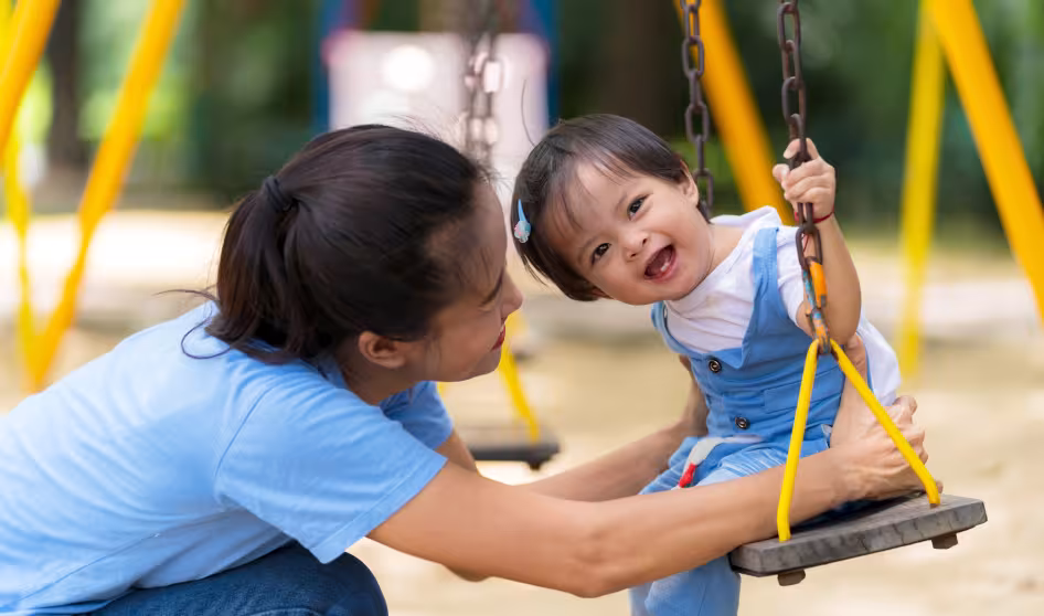 Mother and daughter playing on a playground