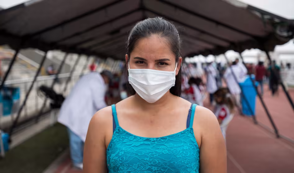 A Venezuelan woman in Ecuador after receiving a COVID-19 vaccine