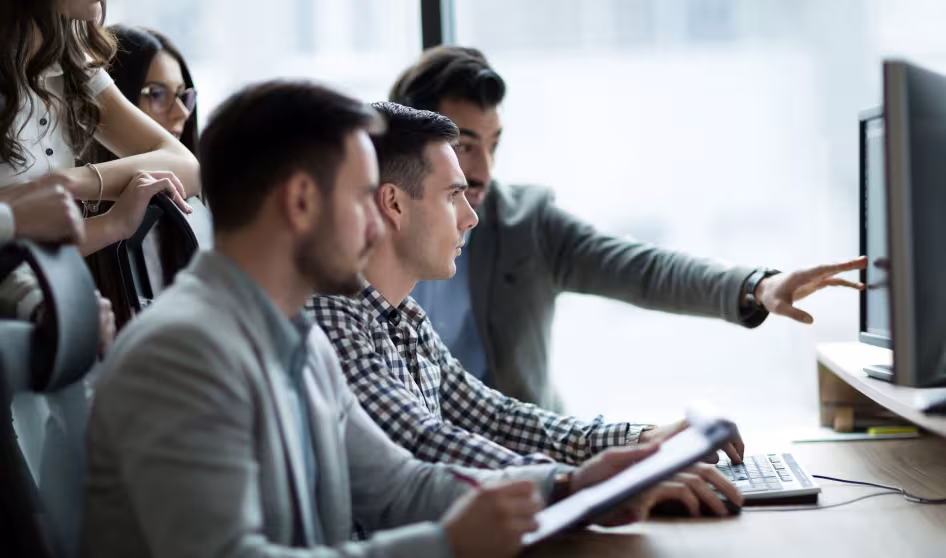 A group of coworkers at a computer
