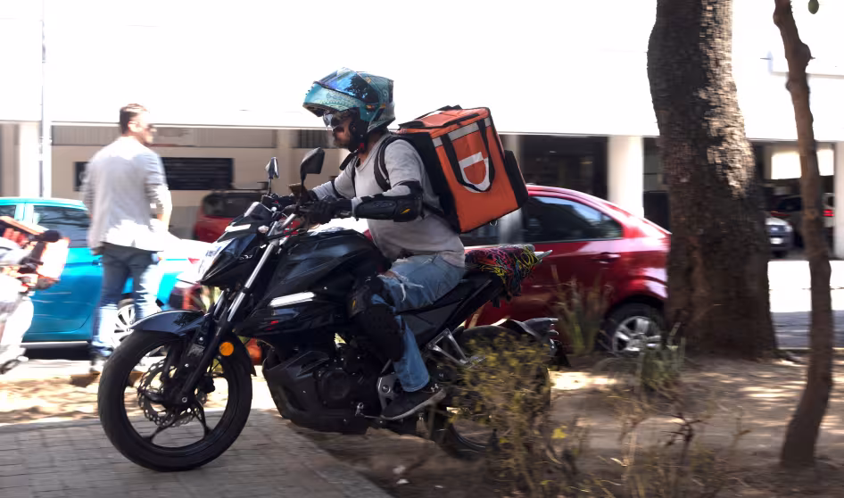 Food delivery service driver on a motorcycle in Mexico