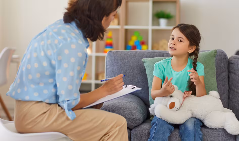 Young girl talks to a child psychologist