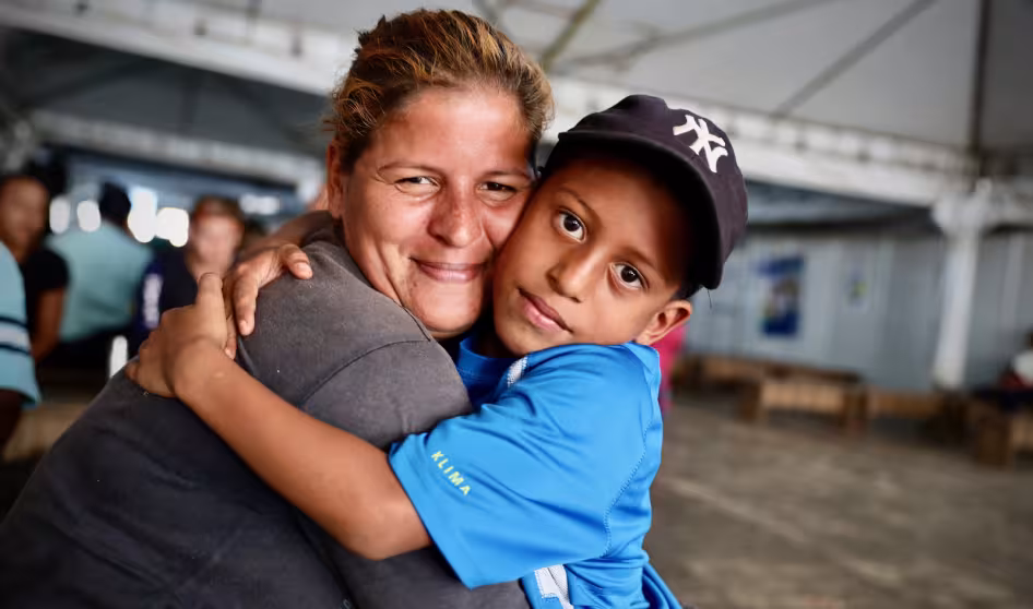 Venezuelan mother and son embrace at a reception center in Brazil