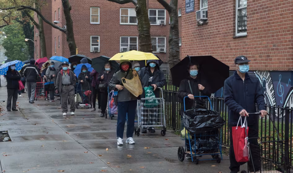 A crowd of people outside a food pantry