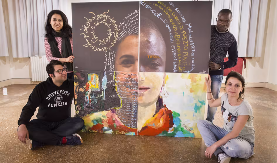 Four refugee artists stand with art they have created that will be shown at the Venice Biennale
