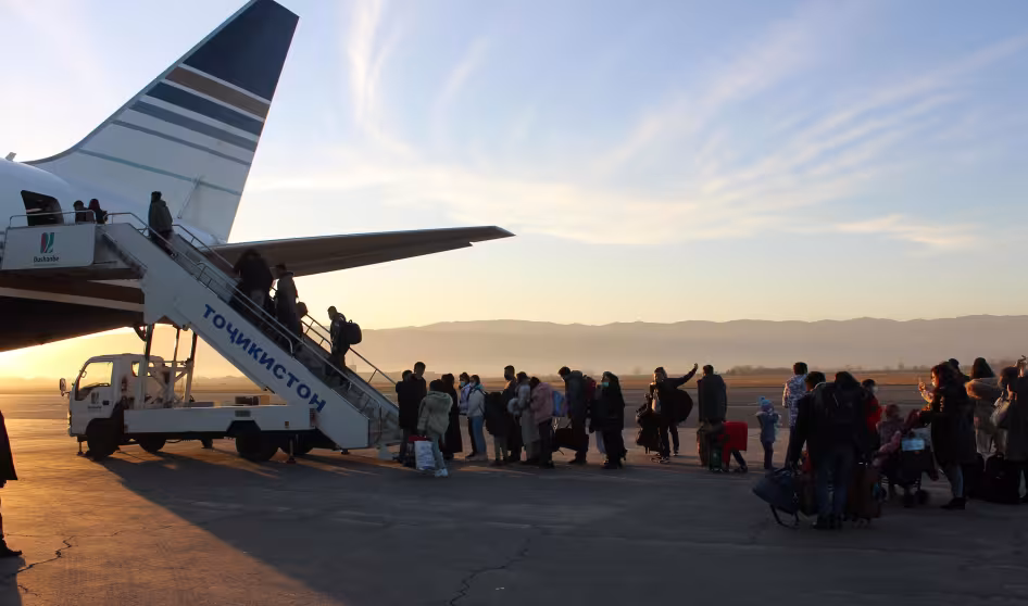 Afghan refugees board a plane to be resettled