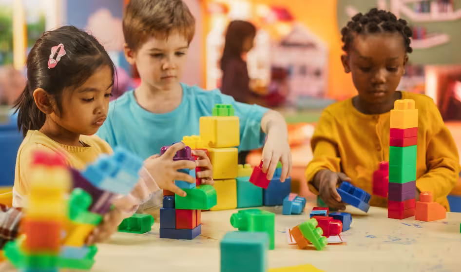 Young children play with building blocks at daycare