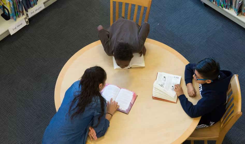 Middle school students studying in a library