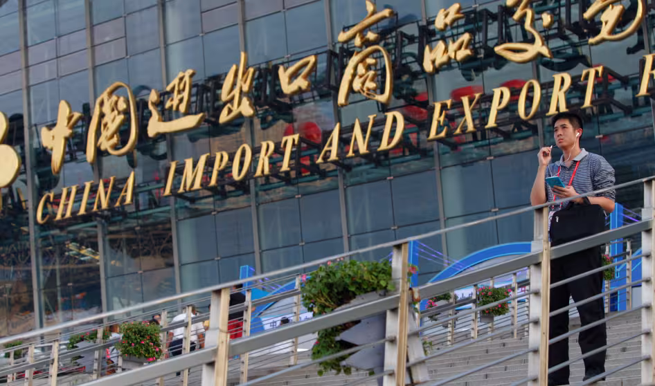 Image of man on steps in front of China Import and Export Fair in Guangzhou, China