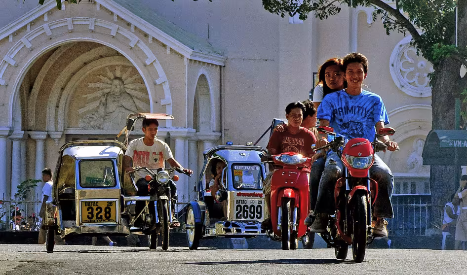 Young people ride motorcycles in Batac, Philippines.
