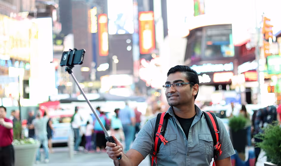 A tourist takes a selfie in New York City.