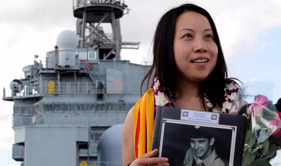 A woman stands onboard the U.S. Navy vessel on which she was born.