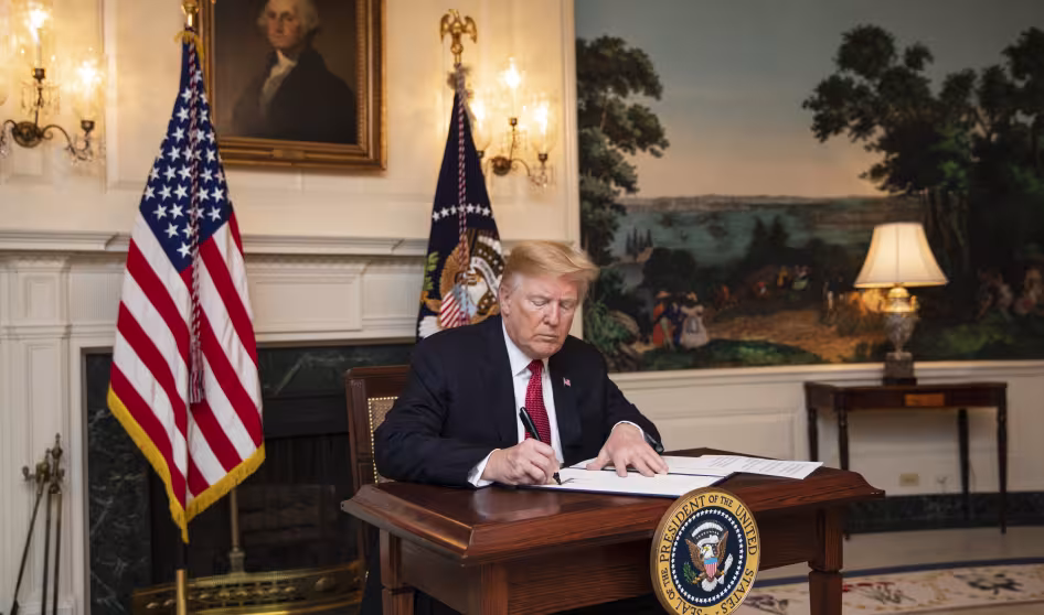 President Trump signs an immigration proclamation at the White House