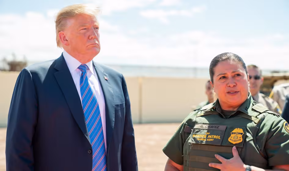 President Trump and a Customs and Border Patrol officer stand together