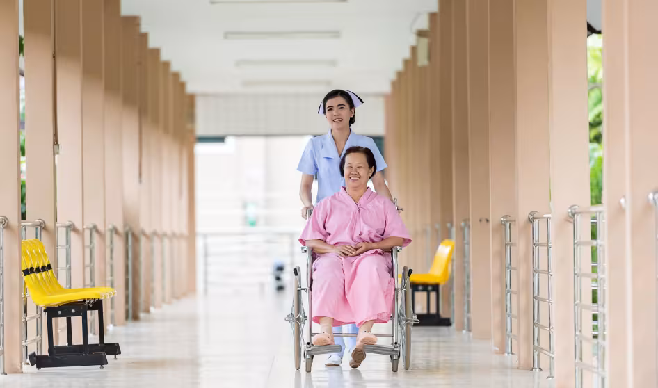 A nurse assists a woman in a wheelchair