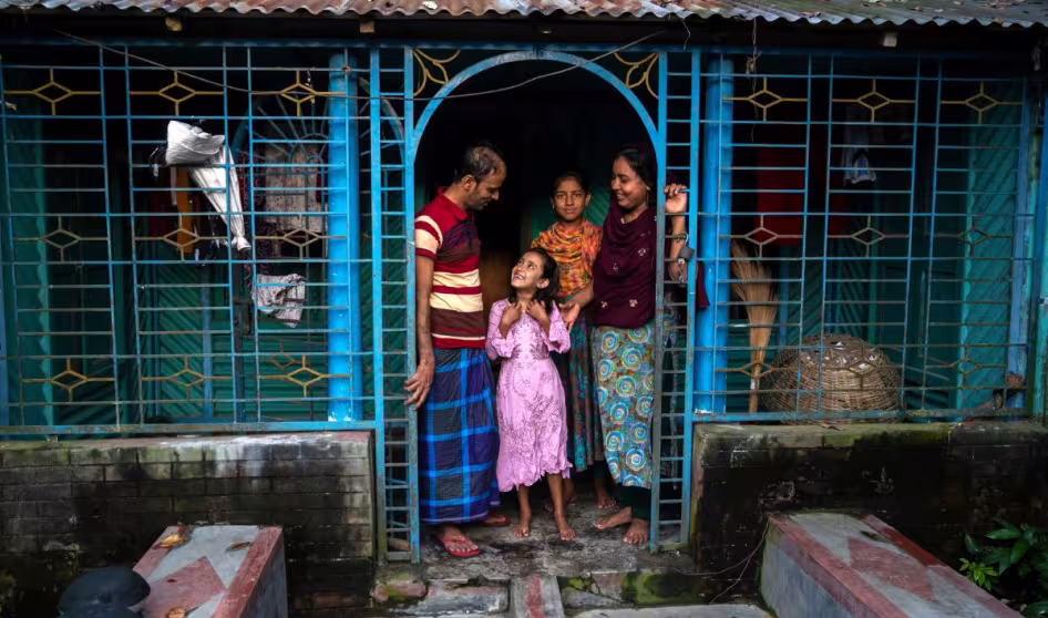 A returned migrant with his family in Bangladesh