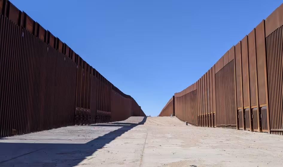 A double border wall leads to a boat launch in Yuma, Arizona.