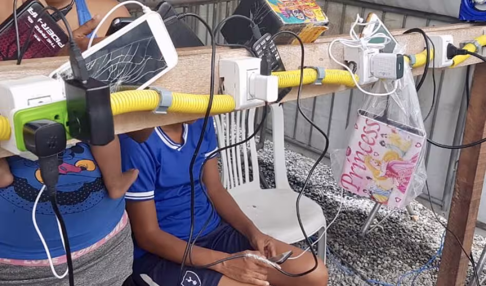 Venezuelan migrants charge their phones and other devices at a power point in Boa Vista, Brazil.