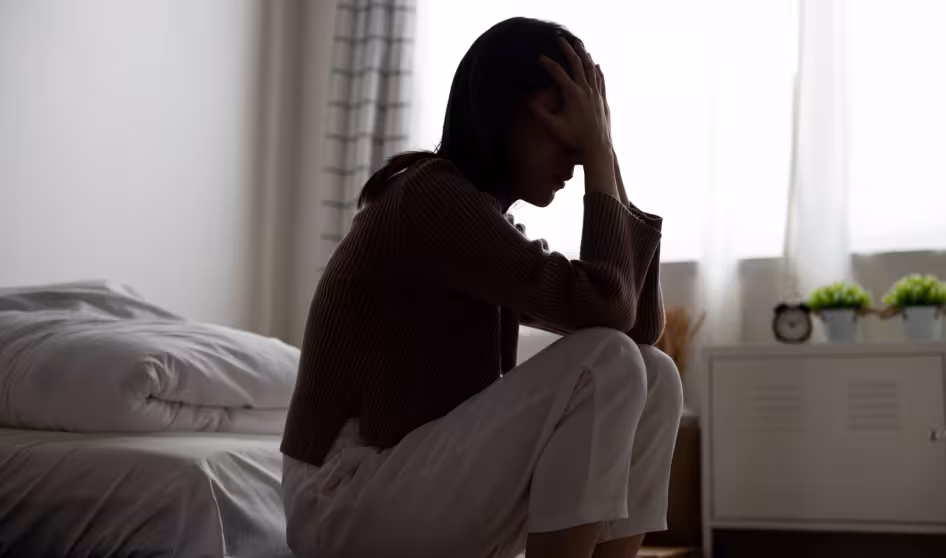 A woman crying in her room.