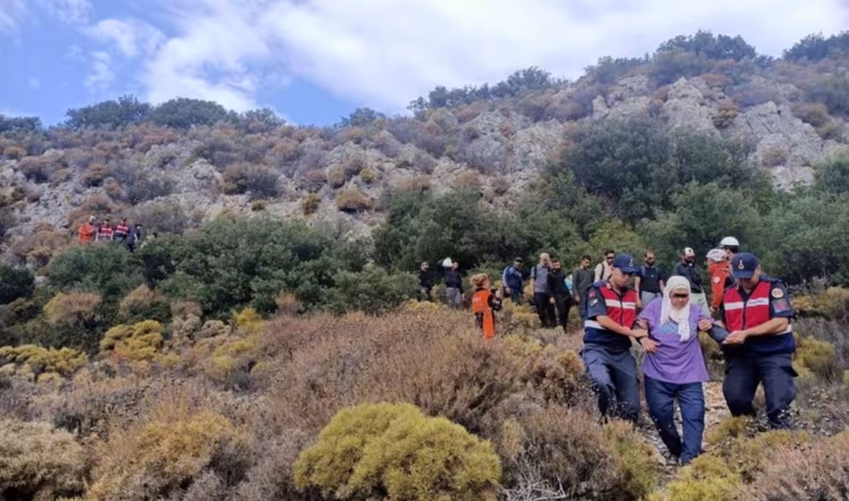 Turkish authorities assist a migrant.