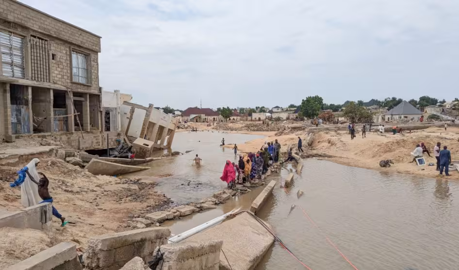 People walk through floodwaters in Nigeria.
