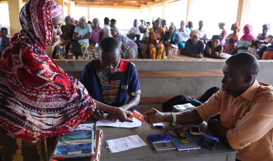 A woman receives a cash transfer in Sierra Leone. 