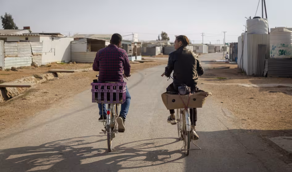 People ride bicycles in the Za'atari refugee camp in Jordan.