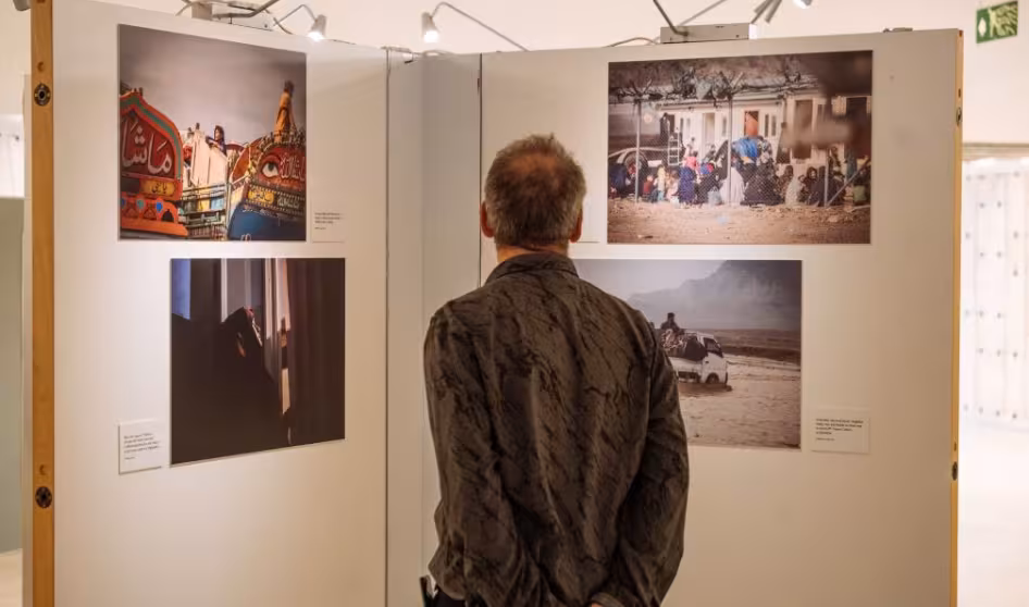 A person views photos in an art exhibition